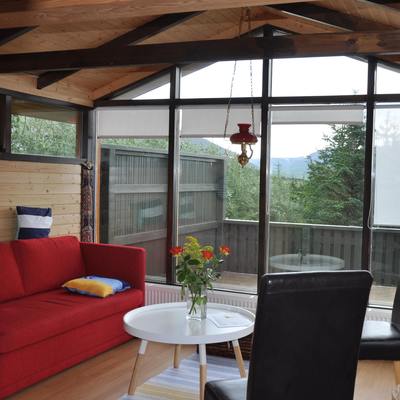 A comfortable sofa and chairs in the living room with access to the terrace