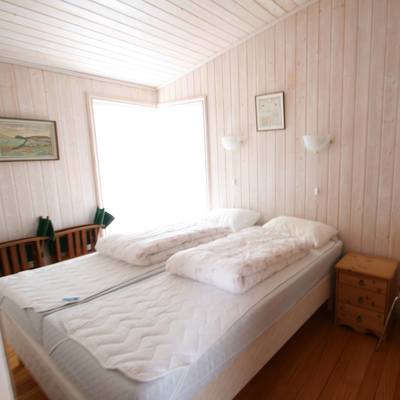 Light-flooded bedroom with chest of drawers
