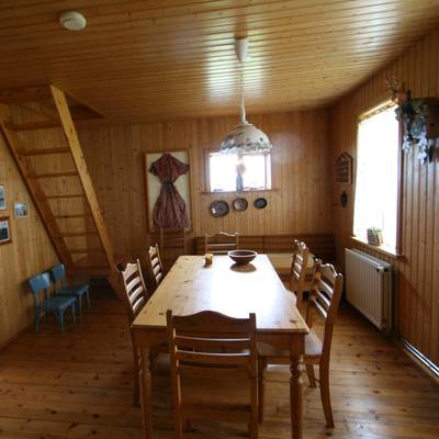 In the dining room, a large table awaits up to 6 guests