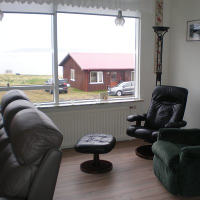 In the living room, armchairs and a couch await guests
