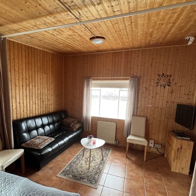 Bedroom with double bed and curtain to the living area