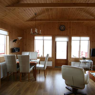 The house is wood paneled. The dining and living areas are next to each other and are very comfortably furnished